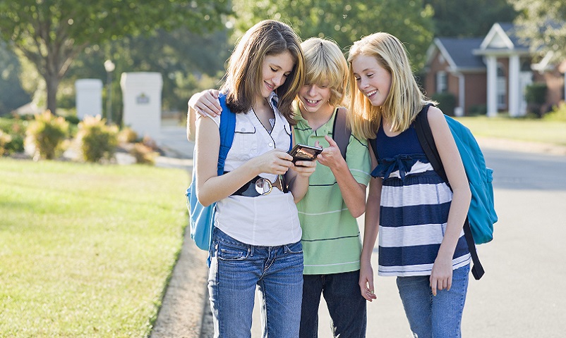 Group of Friends with Cell Phone Going to School